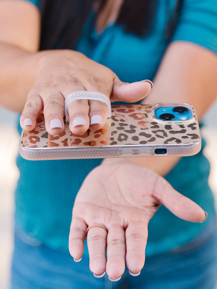  A woman holding a Gold Leopard Loopy Case.|| feature-media