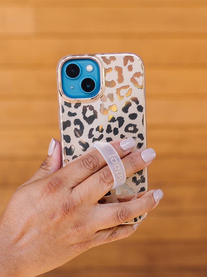  A woman holding a Gold Leopard Loopy Case.|| feature-media