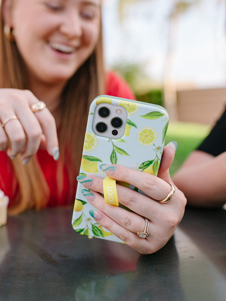  A woman holding a Lemons Loopy Case.|| feature-media