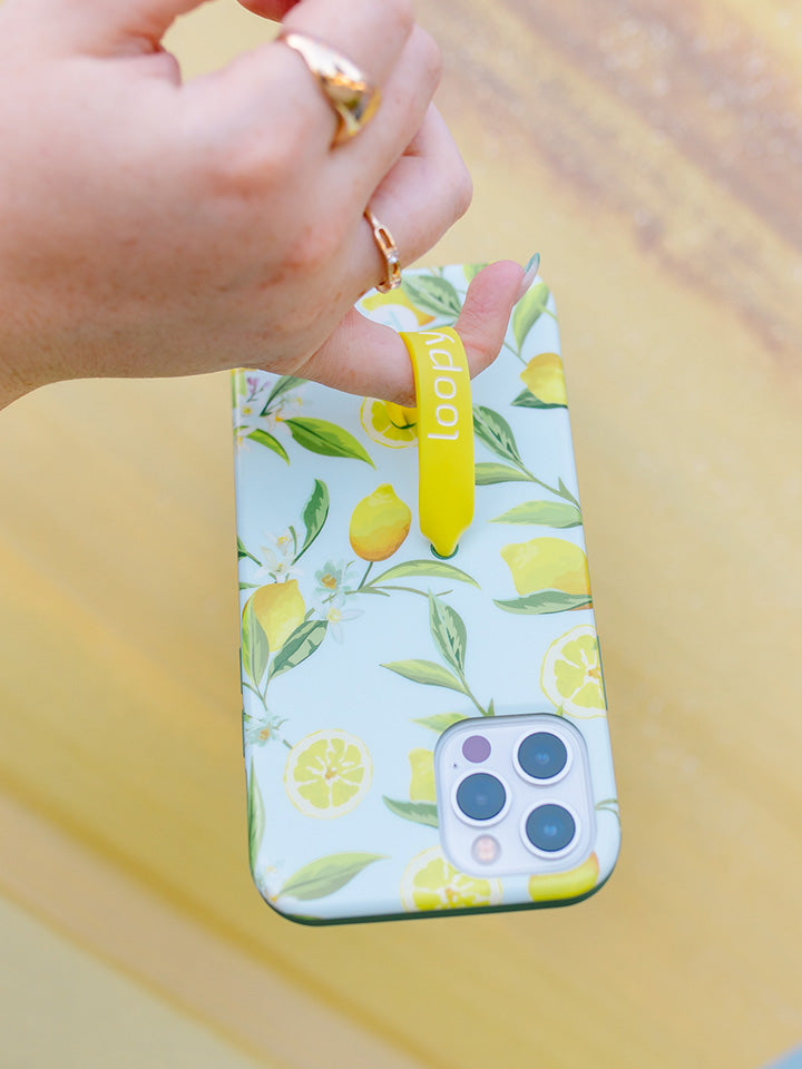 A woman holding a Lemons Loopy Case.|| feature-media