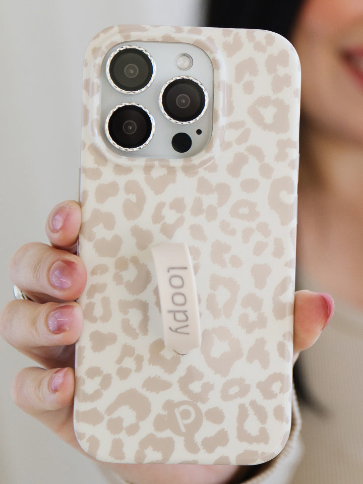 A woman holding a Taupe Leopard Loopy Case. || feature-media