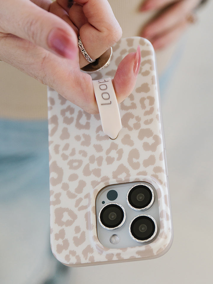 A woman holding a Taupe Leopard Loopy Case. || feature-media