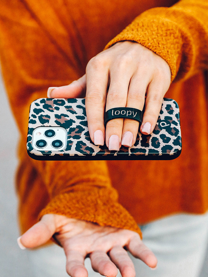 A woman holding a Leopard Loopy Case. || feature-media