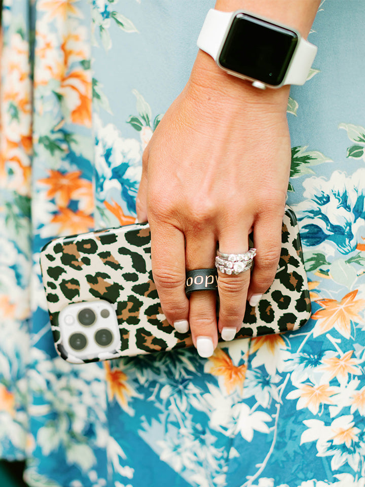 A woman holding a Leopard Loopy Case. || feature-media