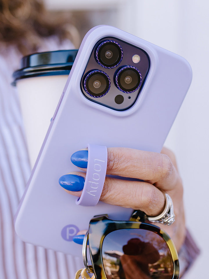 A woman holding a Lilac Loopy Case. || feature-media