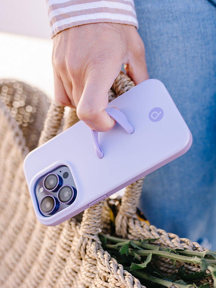 A woman holding a Lilac Loopy Case. || feature-media