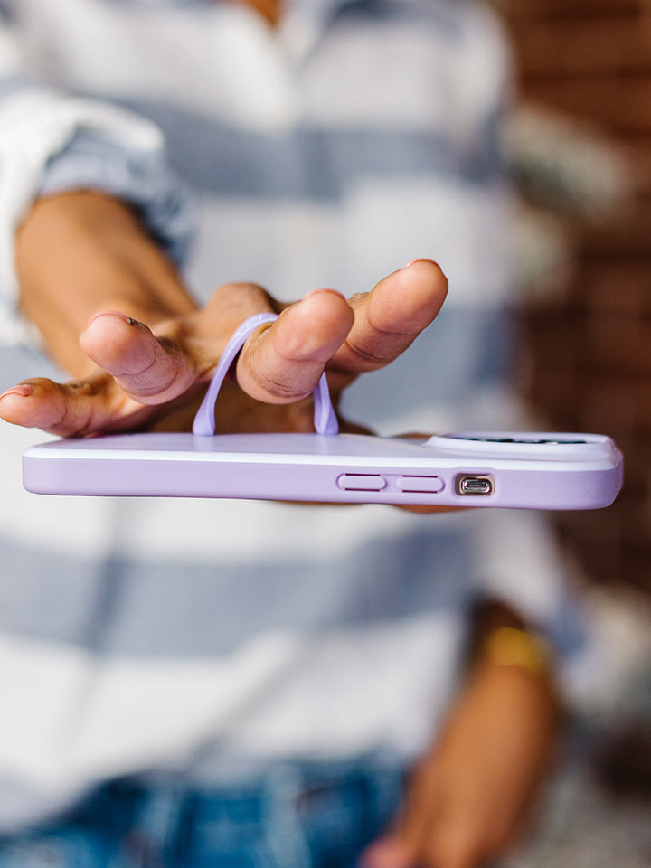 A woman holding a Lilac Loopy Case. || feature-media