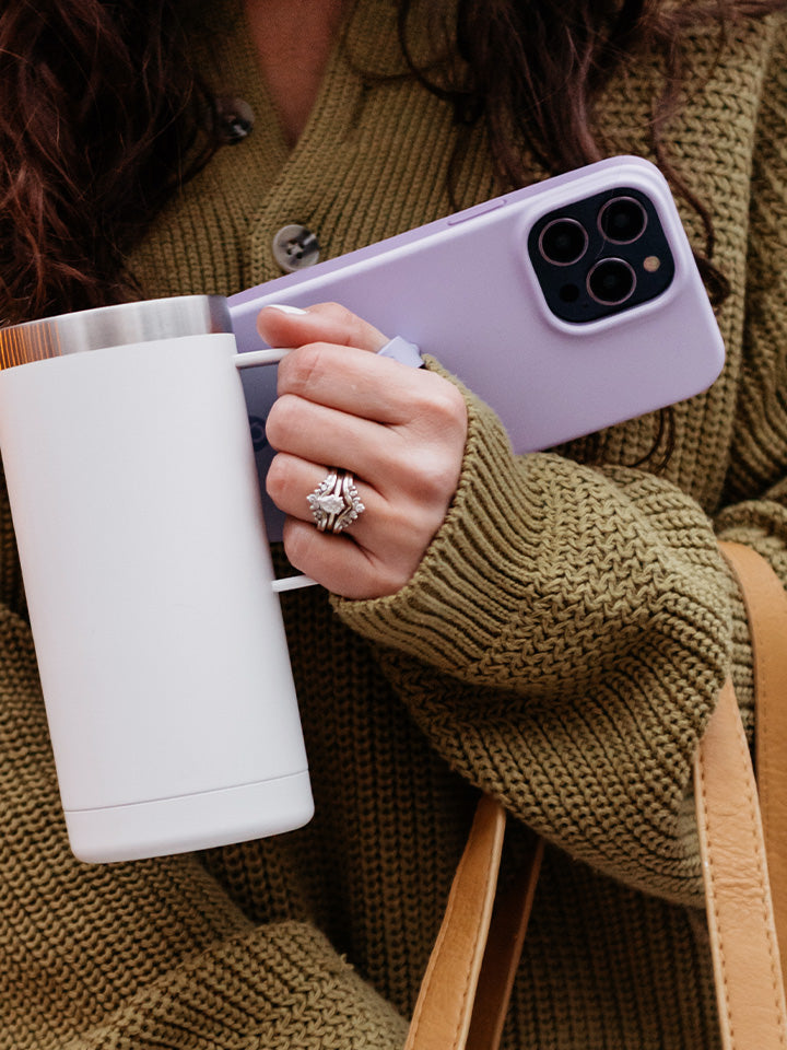 A woman holding a Lilac Loopy Case. || feature-media