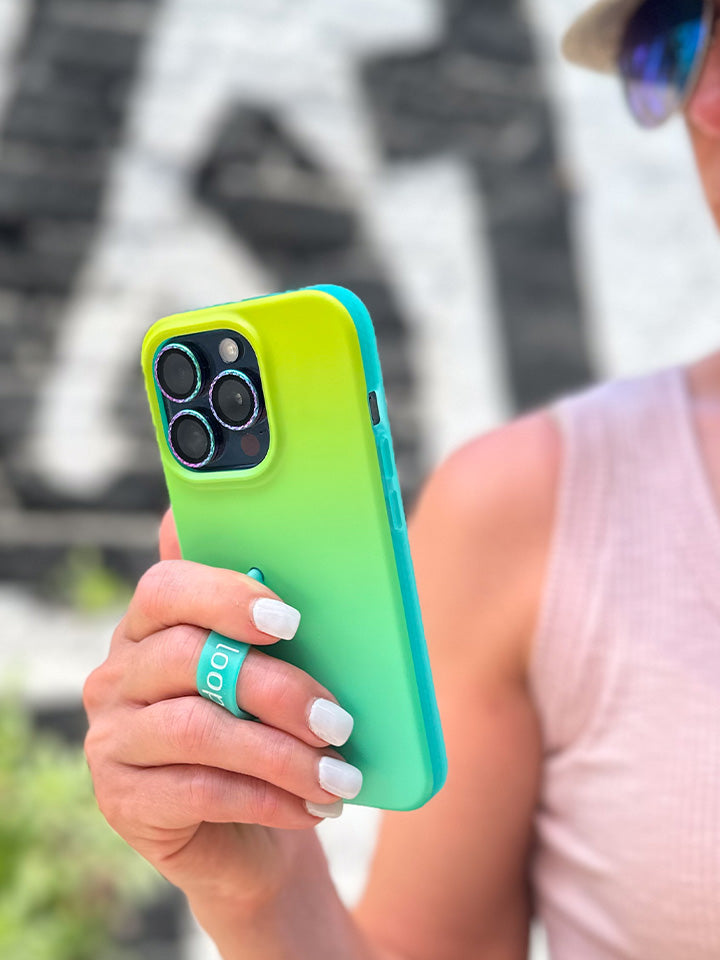 A woman holding a Lime Ombre Loopy Case.|| feature-media