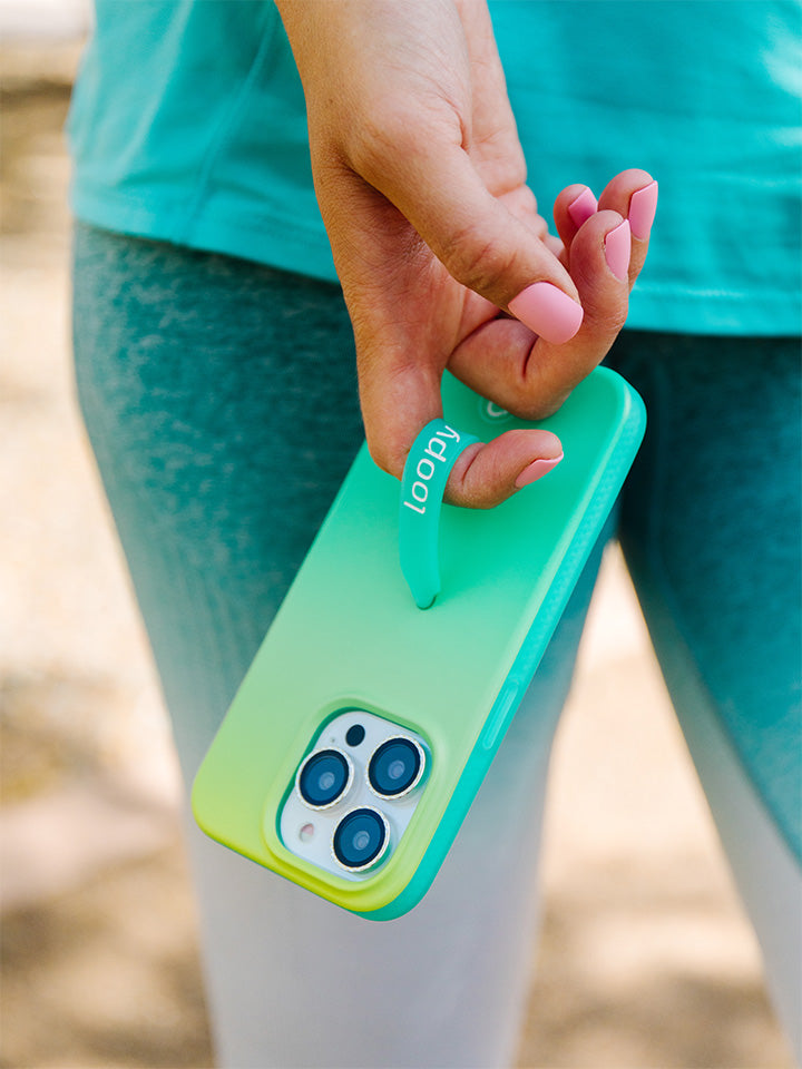 A woman holding a Lime Ombre Loopy Case.|| feature-media