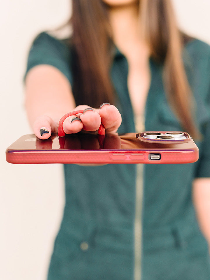 A woman holding a Maroon Shimmer Loopy Case.|| feature-media