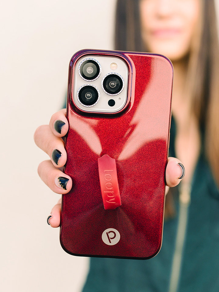 A woman holding a Maroon Shimmer Loopy Case.|| feature-media