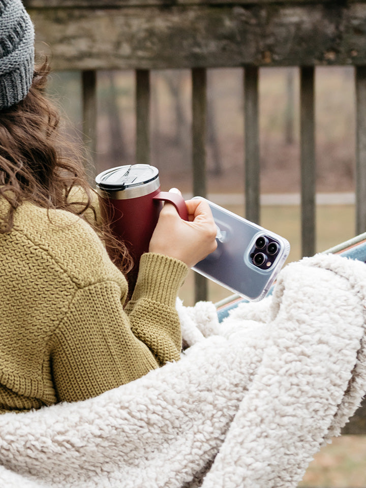 A woman holding a Matte Clear Loopy Case.|| feature-media