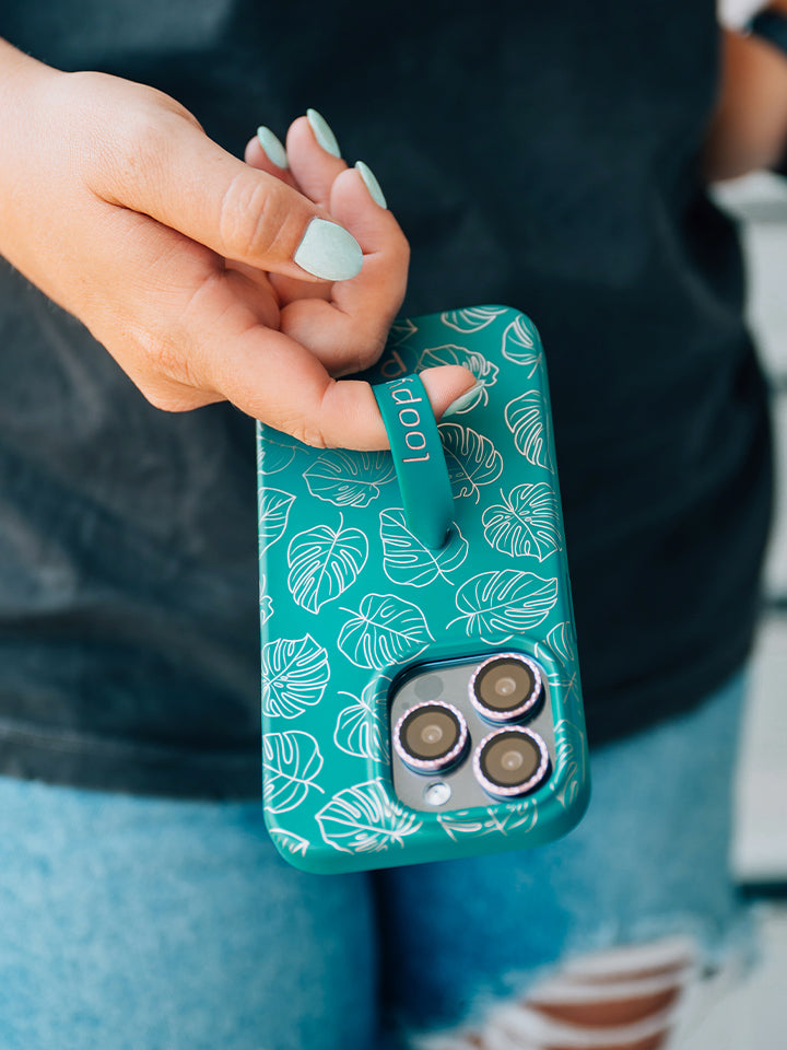 A woman holding a Metallic Monstera Loopy Case. || feature-media