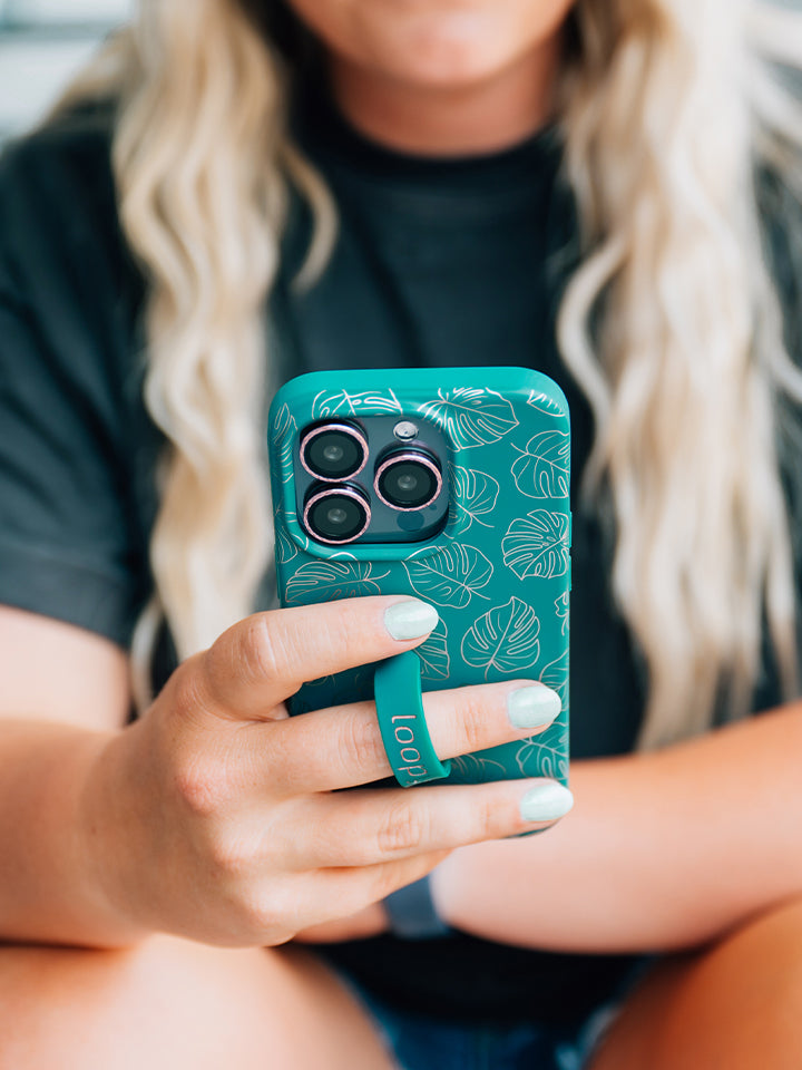  A woman holding a Metallic Monstera Loopy Case.|| feature-media