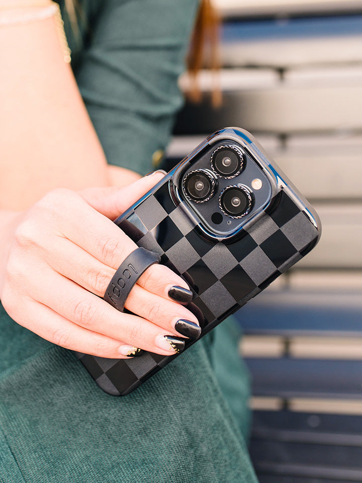 A woman holding a Midnight Checkered Loopy Case. || feature-media