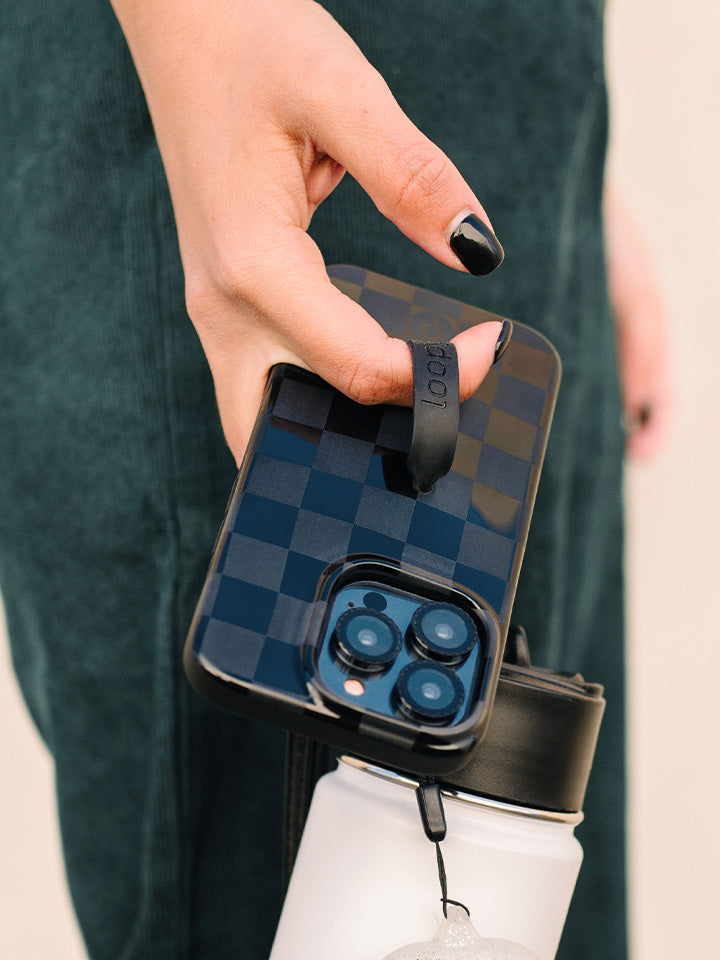 A woman holding a Midnight Checkered Loopy Case. || feature-media