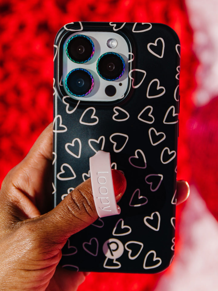 A woman holding a Midnight Hearts Loopy Case. || feature-media