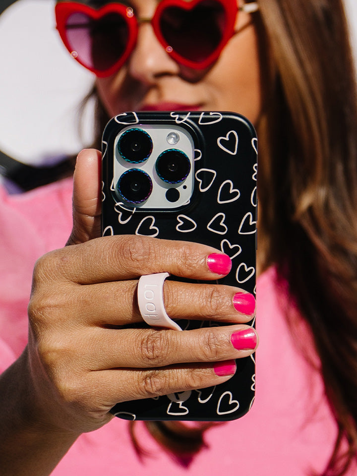 A woman holding a Midnight Hearts Loopy Case. || feature-media