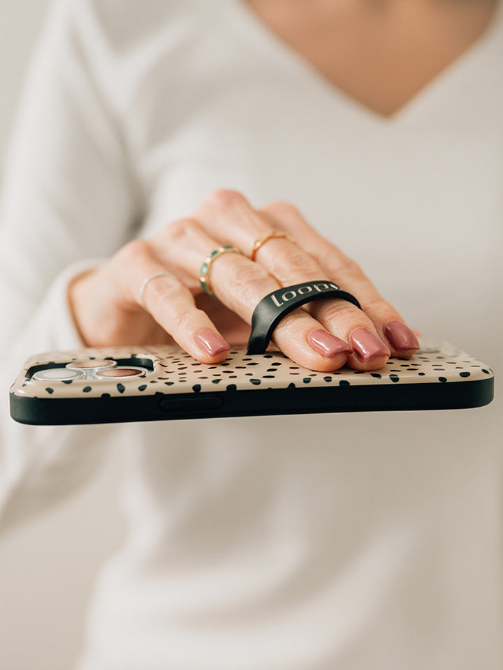 A woman holding a Mocha Dots Loopy Case.|| feature-media