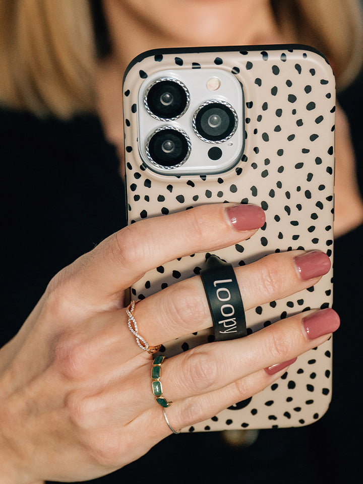 A woman holding a Mocha Dots Loopy Case.|| feature-media