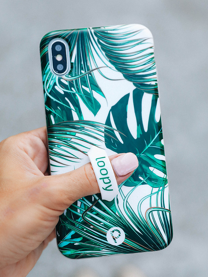 A woman holding a Monstera Loopy Case. || feature-media