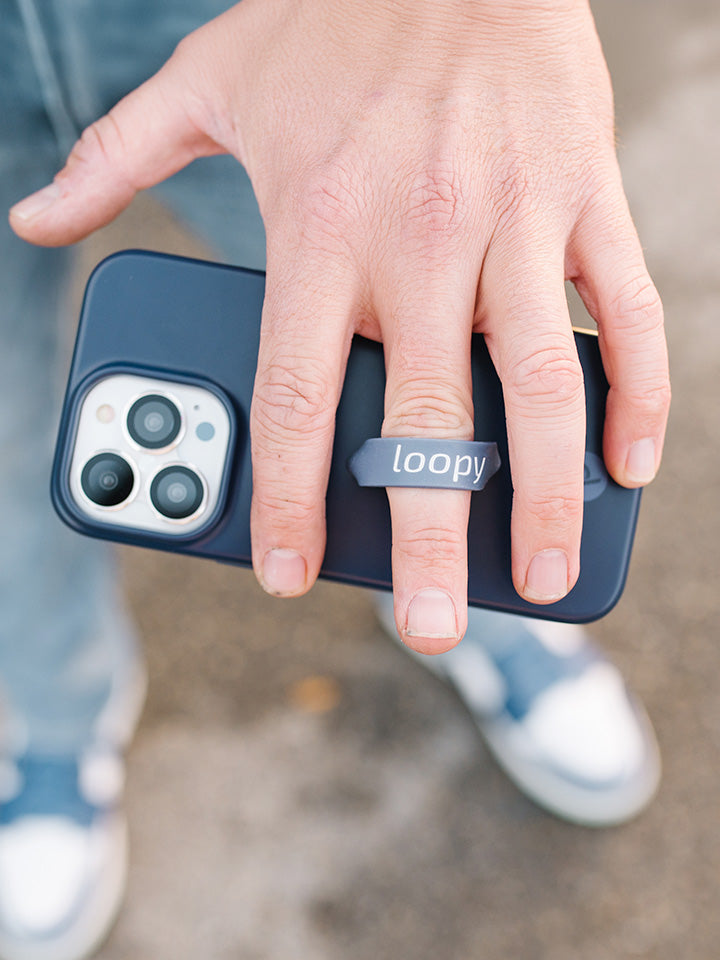 A man holding a Navy Loopy Case. || feature-media