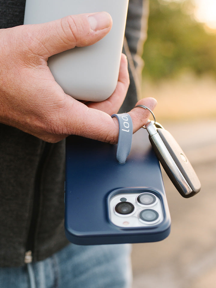 A man holding a Navy Loopy Case. || feature-media