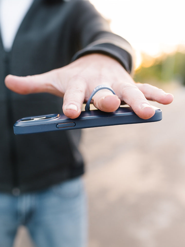 A man holding a Navy Loopy Case. || feature-media