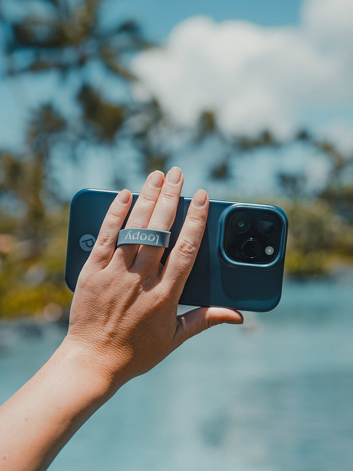 A woman holding a Navy Loopy Case. || feature-media