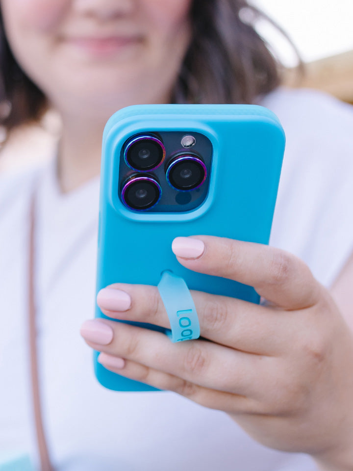 A woman holding a Neon Cyan Loopy Case.|| feature-media