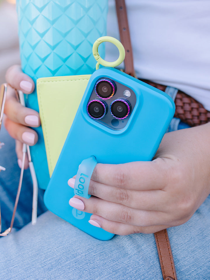 A woman holding a Neon Cyan Loopy Case.|| feature-media