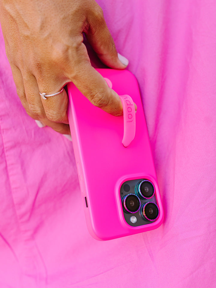 A woman holding a Neon Magenta Loopy Case.|| feature-media