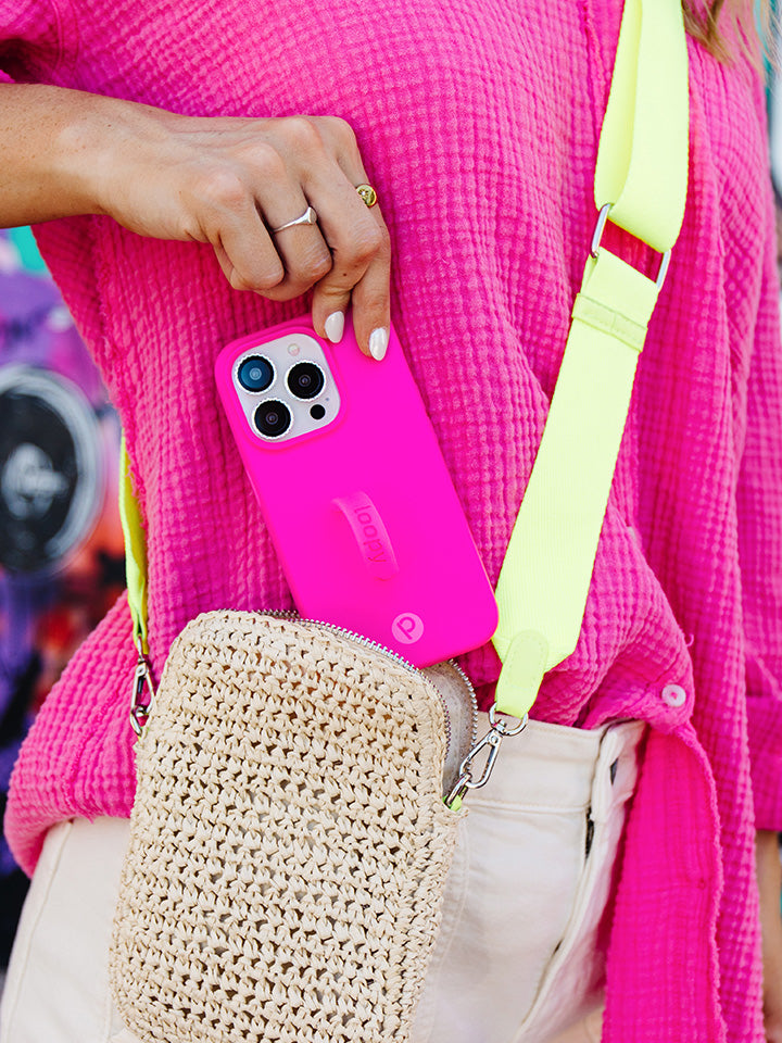 A woman holding a Neon Magenta Loopy Case.|| feature-media