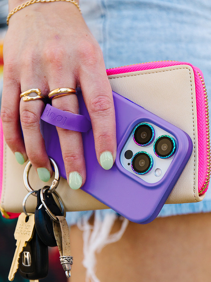 A woman holding a Neon Violet Loopy Case.|| feature-media