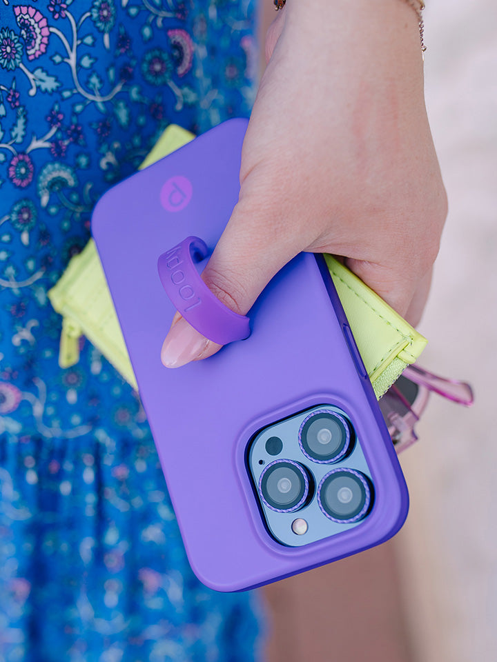 A woman holding a Neon Violet Loopy Case.|| feature-media