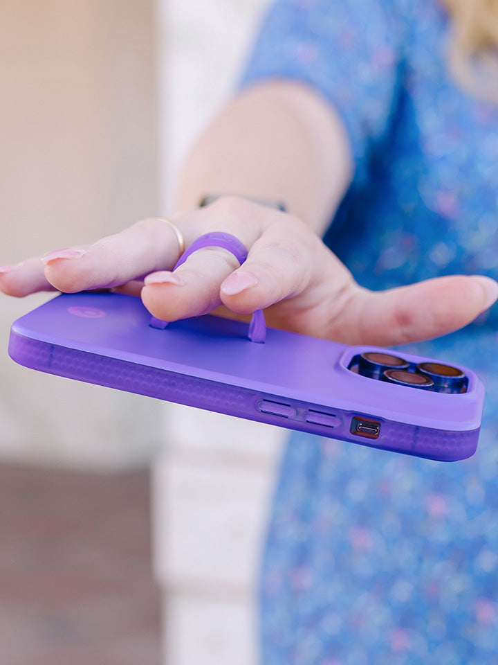 A woman holding a Neon Violet Loopy Case.|| feature-media