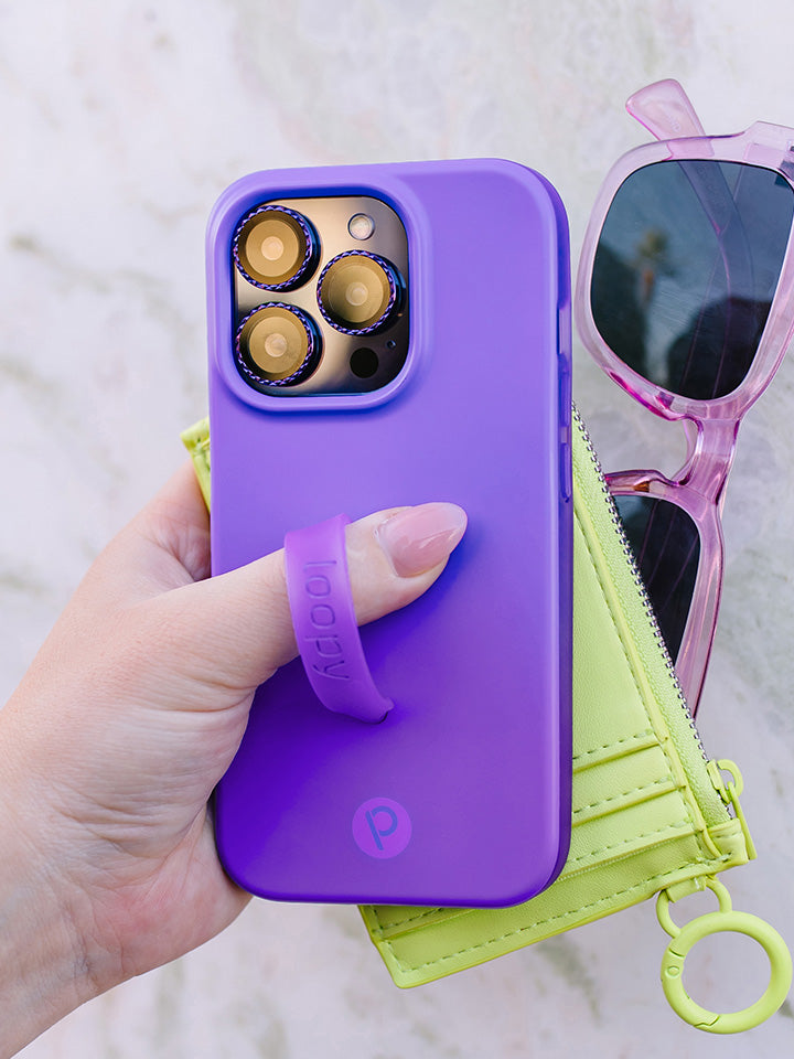 A woman holding a Neon Violet Loopy Case.|| feature-media