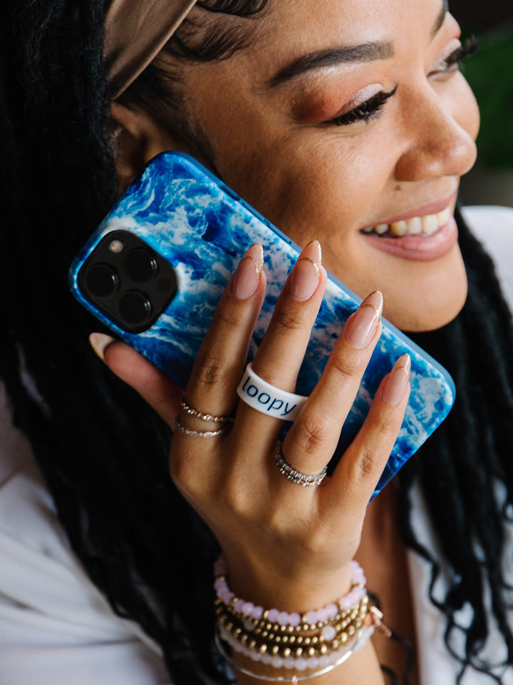 A woman holding an Ocean Loopy Case.|| feature-media