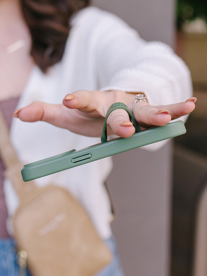  A woman holding an Olive Loopy Case.|| feature-media