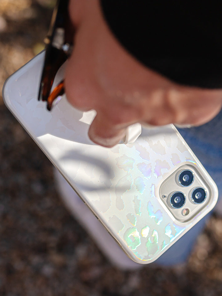 A woman holding an Opal Leopard Loopy Case.|| feature-media