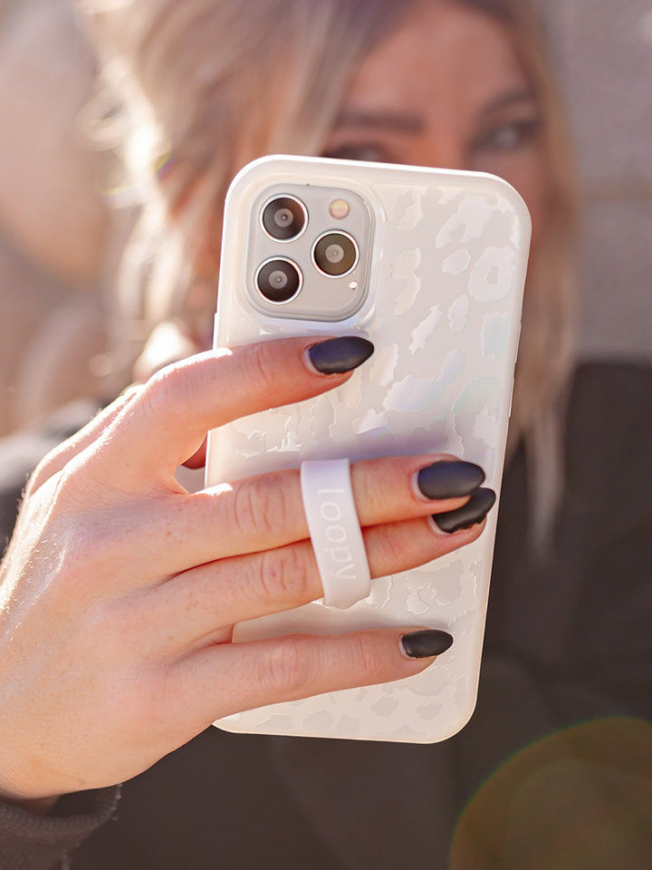 A woman holding an Opal Leopard Loopy Case.|| feature-media