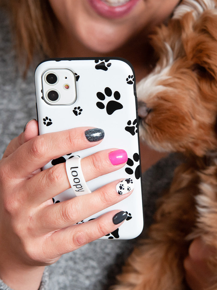 A woman holding a Pawprints Loopy Case. || feature-media