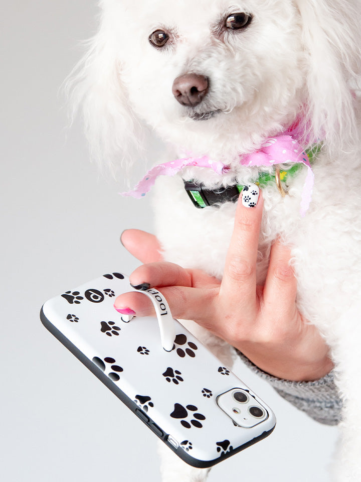 A woman holding a Pawprints Loopy Case. || feature-media