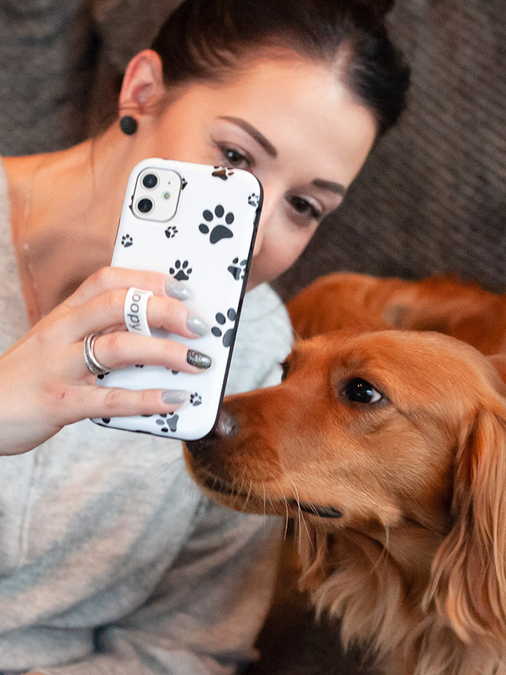 A woman holding a Pawprints Loopy Case. || feature-media