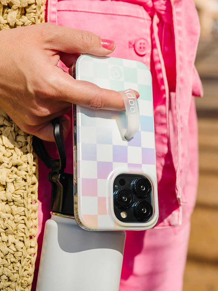 A woman holding a Pearl Checkered Loopy Case.|| feature-media