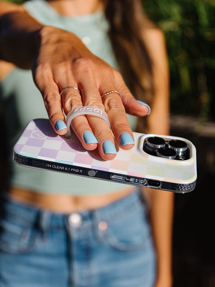 A woman holding a Pearl Checkered Loopy Case.|| feature-media