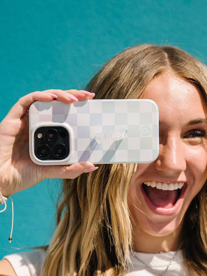 A woman holding a Pearl Checkered Loopy Case.|| feature-media