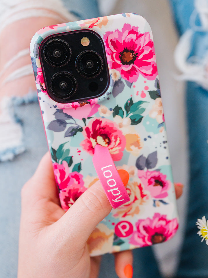 A woman holding a Peonies Loopy Case. || feature-media