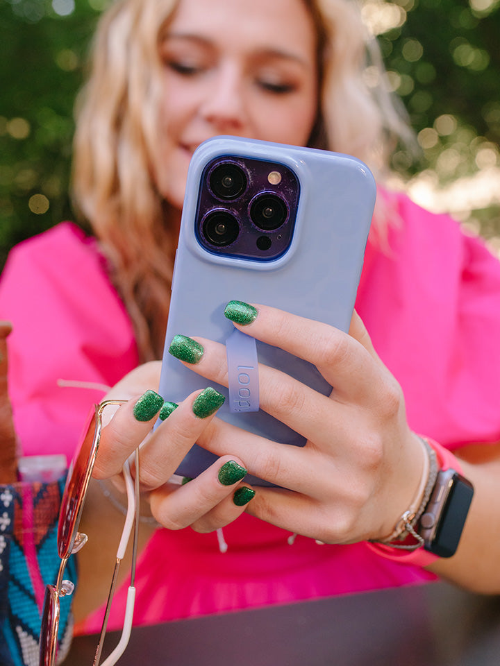 A woman holding a Periwinkle Loopy Case.|| feature-media